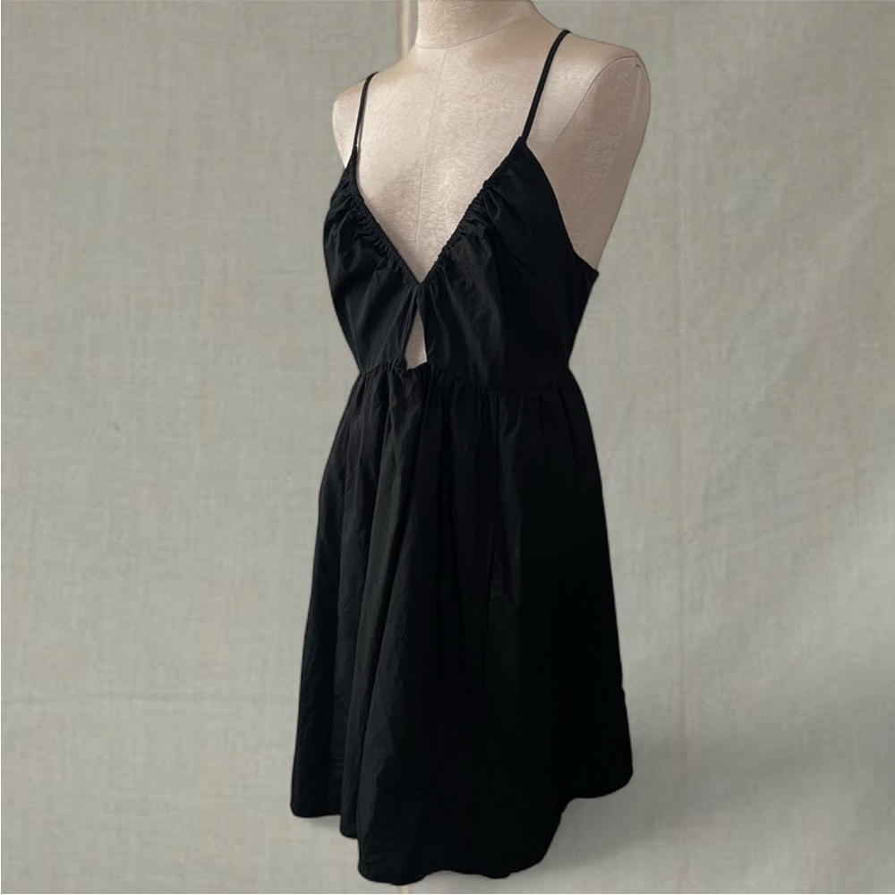Black mini dress with tie detail at back, deep v neck and cutout detail at front